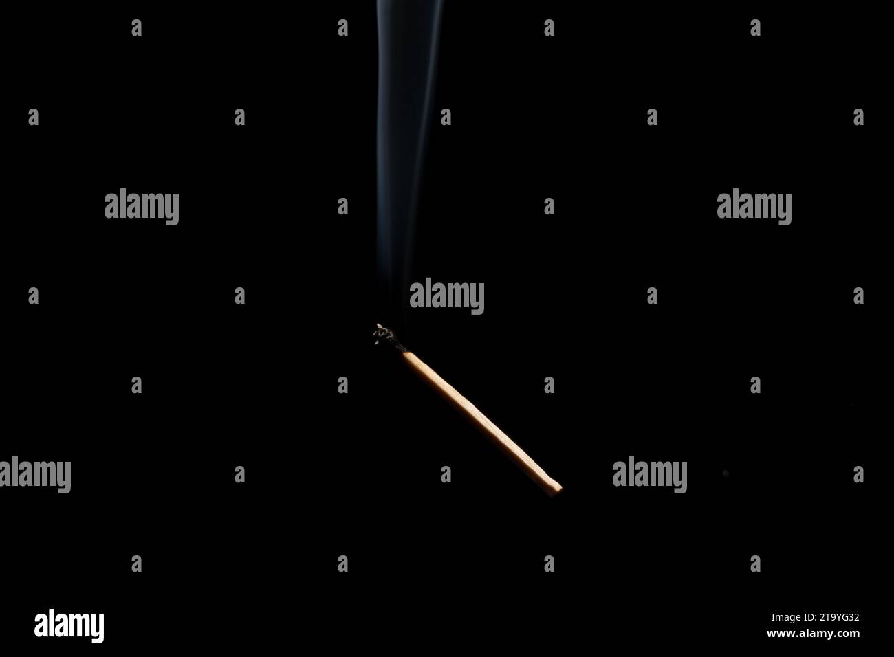 Lit and falling match on a black background. Stock Photo