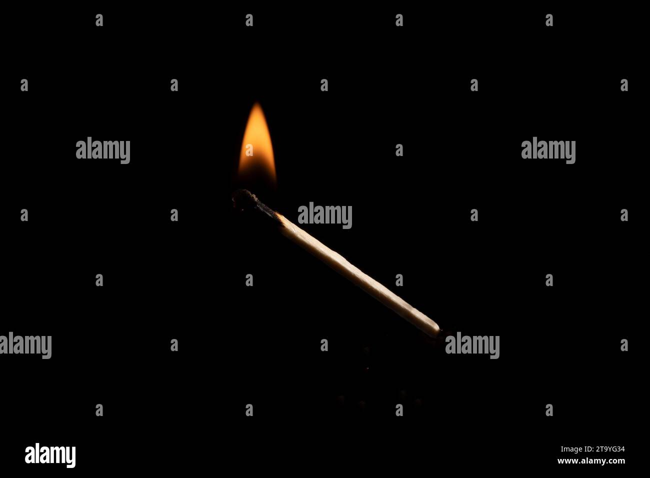 Lit and falling match on a black background. Stock Photo