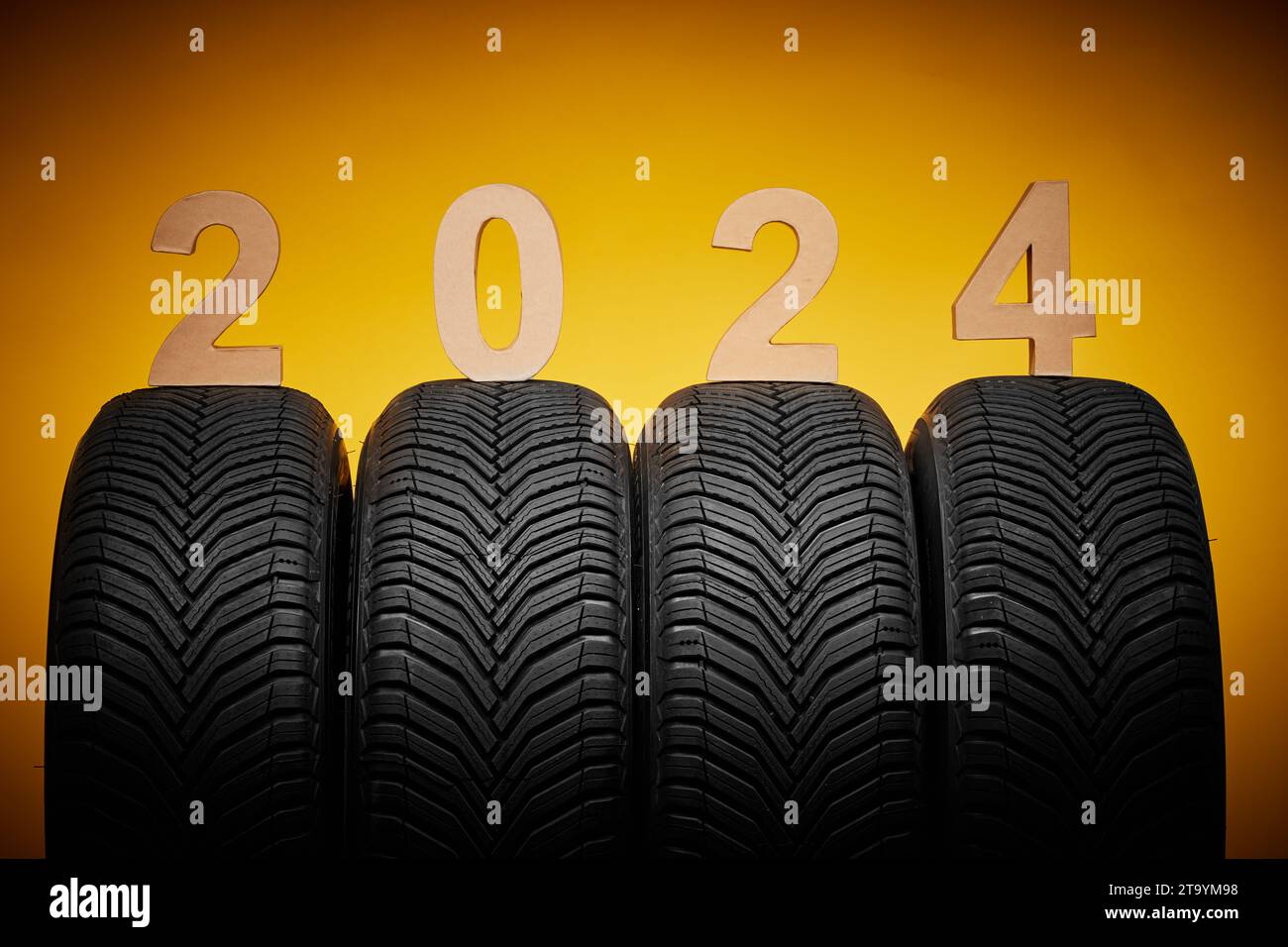 Car tires, new tyres, winter wheels, text happy new year 2024 yellow