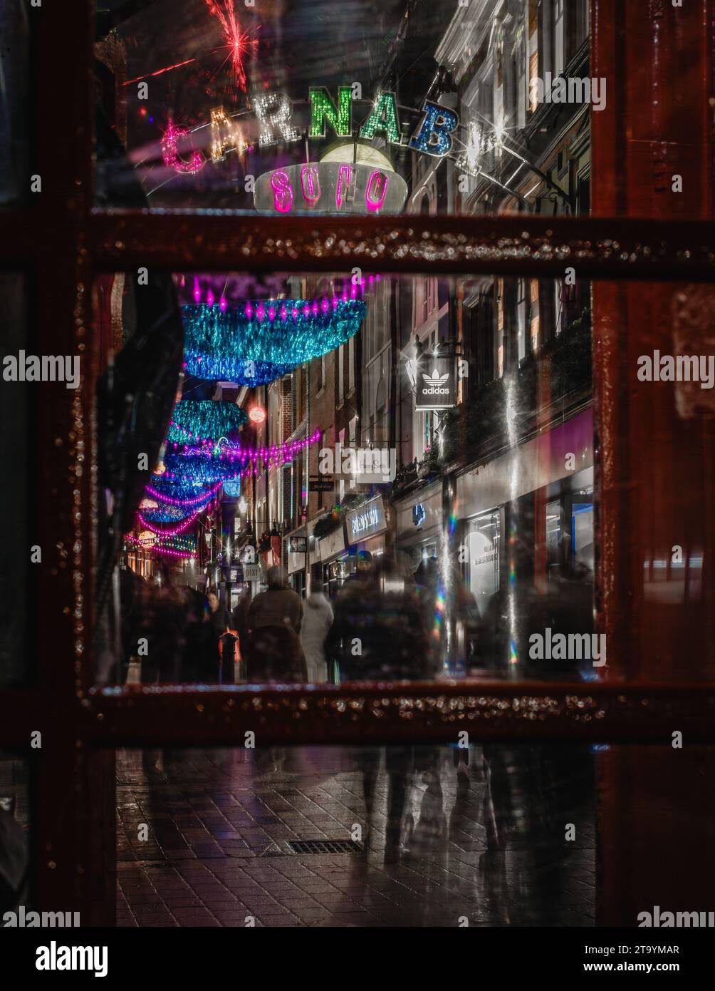 Carnival Soho and christmas lights viewed from a classic red telephone