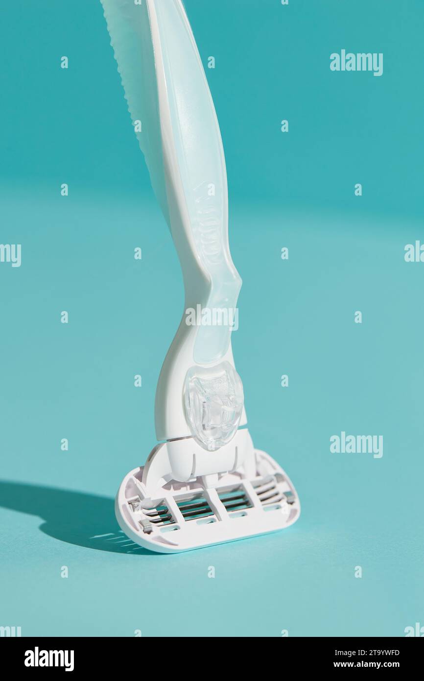 Minimal Razor Design Minimalist elegance: Razor in sharp relief against a bold blue backdrop ...