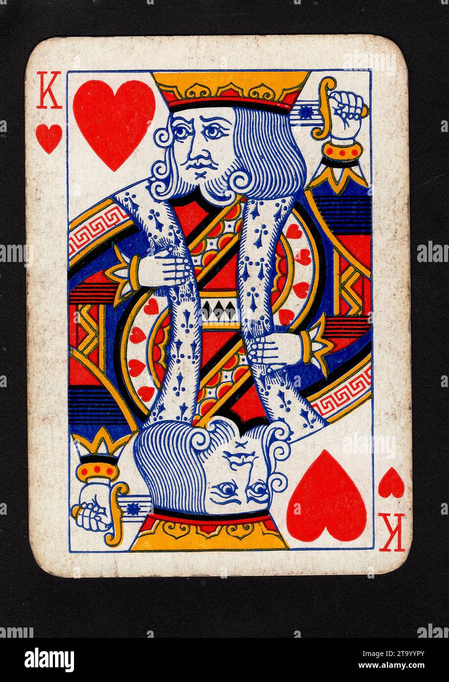 A vintage king of hearts playing card isolated on a black background