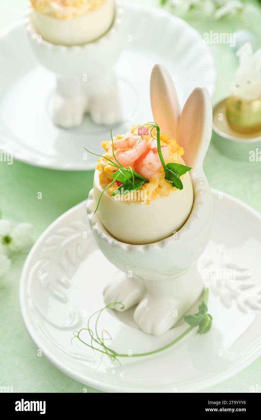 Stuffed or deviled eggs with yolk, shrimp, pea microgreens with paprika ...