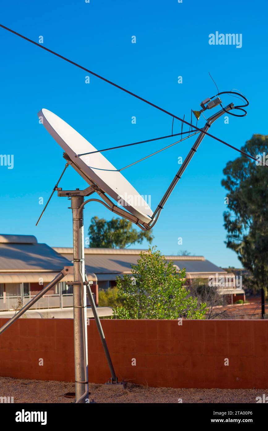 A satellite receiver dish at the remote Yulara Ayers Rock Resort in Central Australia, Northern Territory. Stock Photo