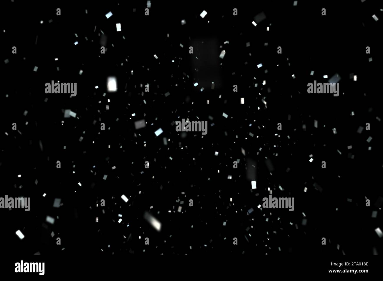 falling silver metallic glitter foil confetti, animation movement on black background, holiday and festive fun concept Stock Photo