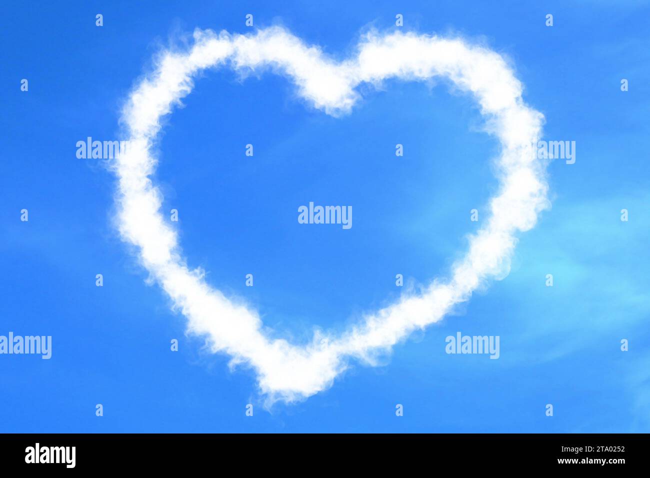 abstract heart shape love draw on the blue sky with white clouds ...