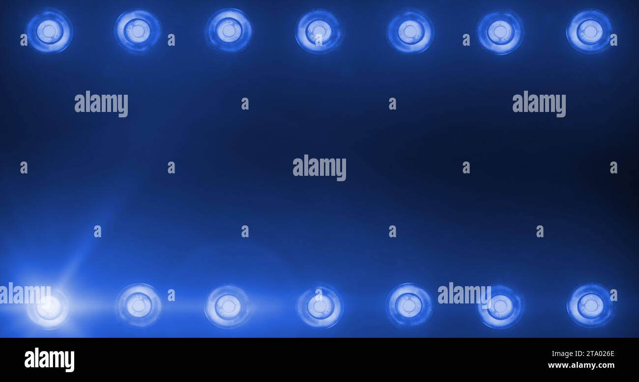 frame of flashing shiny blue stage lights entertainment, spotlight projectors in the dark, blue soft light spotlight strike on black background Stock Photo