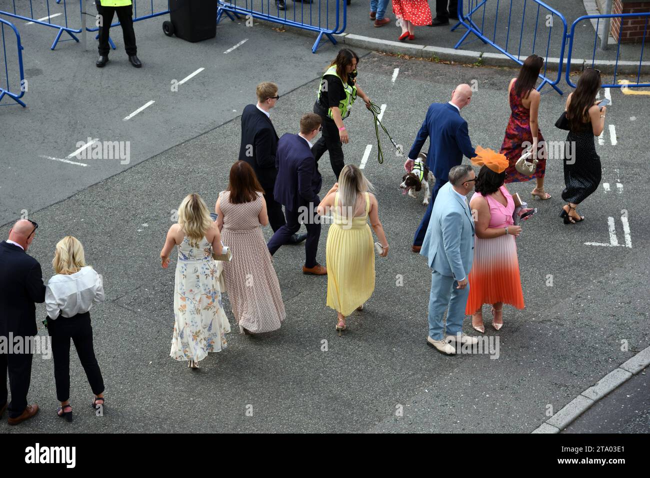 Couples & Women or Female Race Goers wearing Fancy, Fashionable or Colourful Dresses During Ladies Day at Chester Races Chester Racecourse  England UK Stock Photo