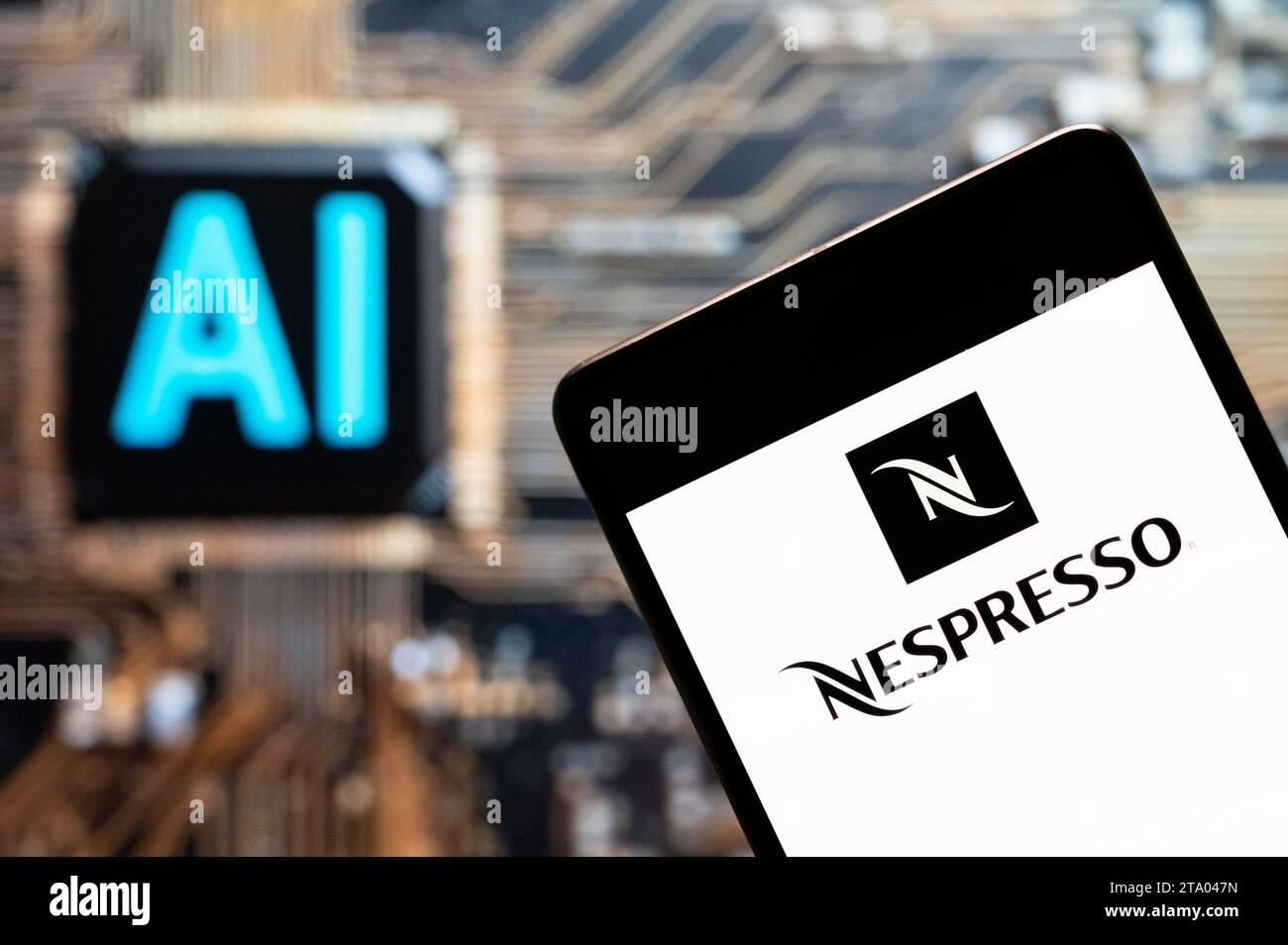China. 3rd Nov, 2023. In this photo illustration, the Swiss high-end and world leader in coffee capsules brand store Nespresso logo seen displayed on a smartphone with an Artificial intelligence (AI) chip and symbol in the background. (Credit Image: © Budrul Chukrut/SOPA Images via ZUMA Press Wire) EDITORIAL USAGE ONLY! Not for Commercial USAGE! Stock Photo