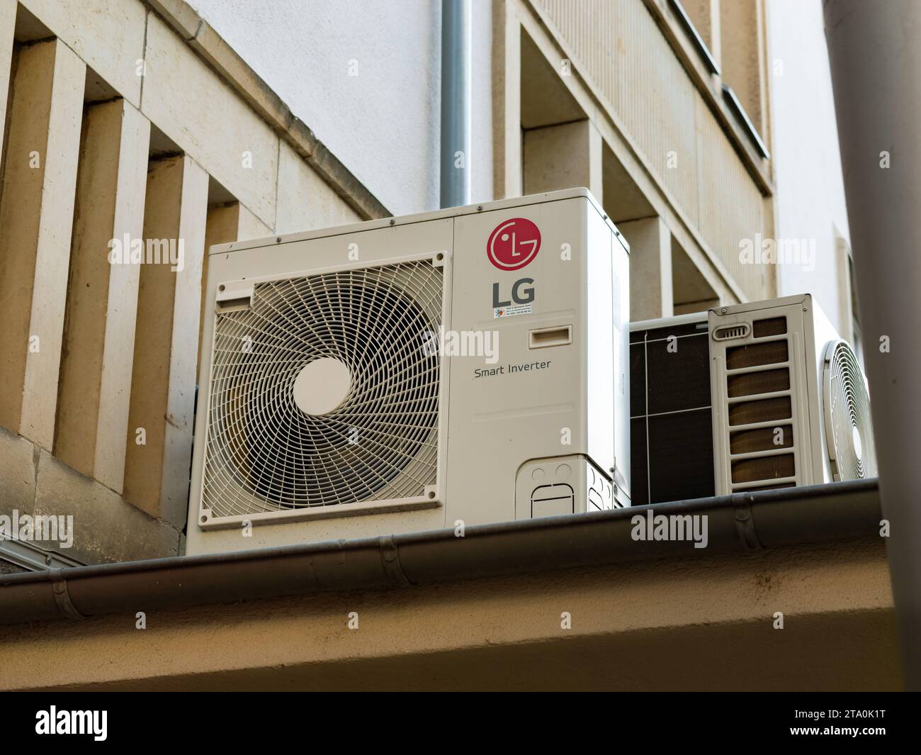 LG Smart Inverter air conditioner on a building exterior. Technology equipment to cool down temperature inside of a house. Ventilator fan outdoors. Stock Photo