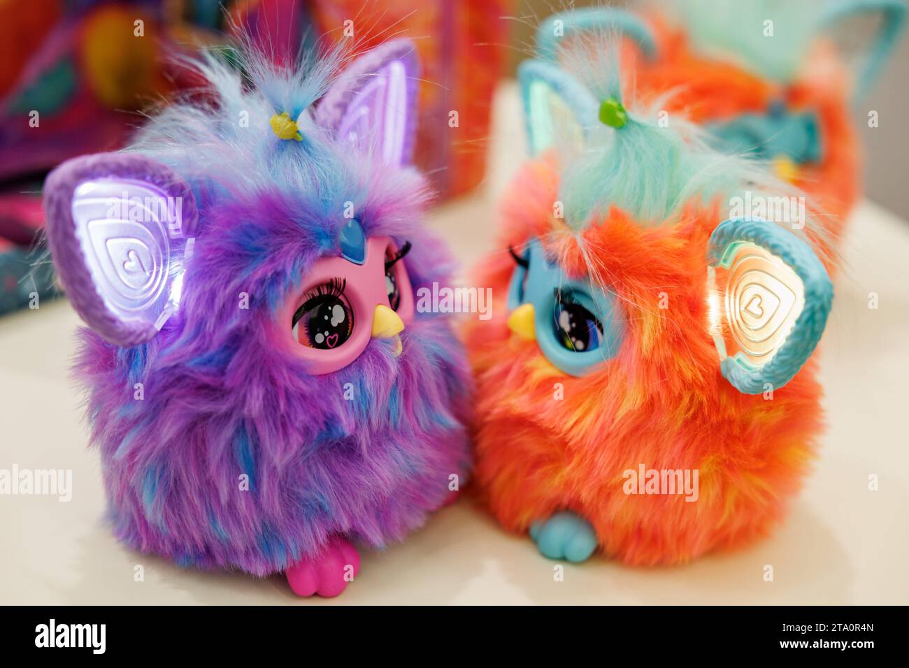 28 November 2023, Bavaria, Nuremberg: The Furby plush figures from Hasbro,  an electronic furry animal, pictured on a table at the annual press  conference of the German Toy Retail Association (BVS) and