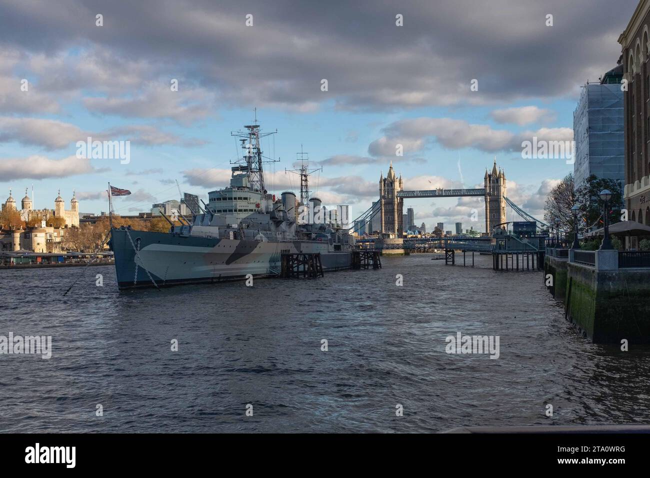HMS Belfast with Tower Bridge and Tower of London in background Stock Photo