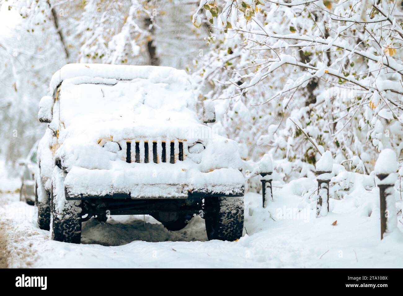 A vintage white Jeep is parked in a picturesque wintery landscape Stock Photo