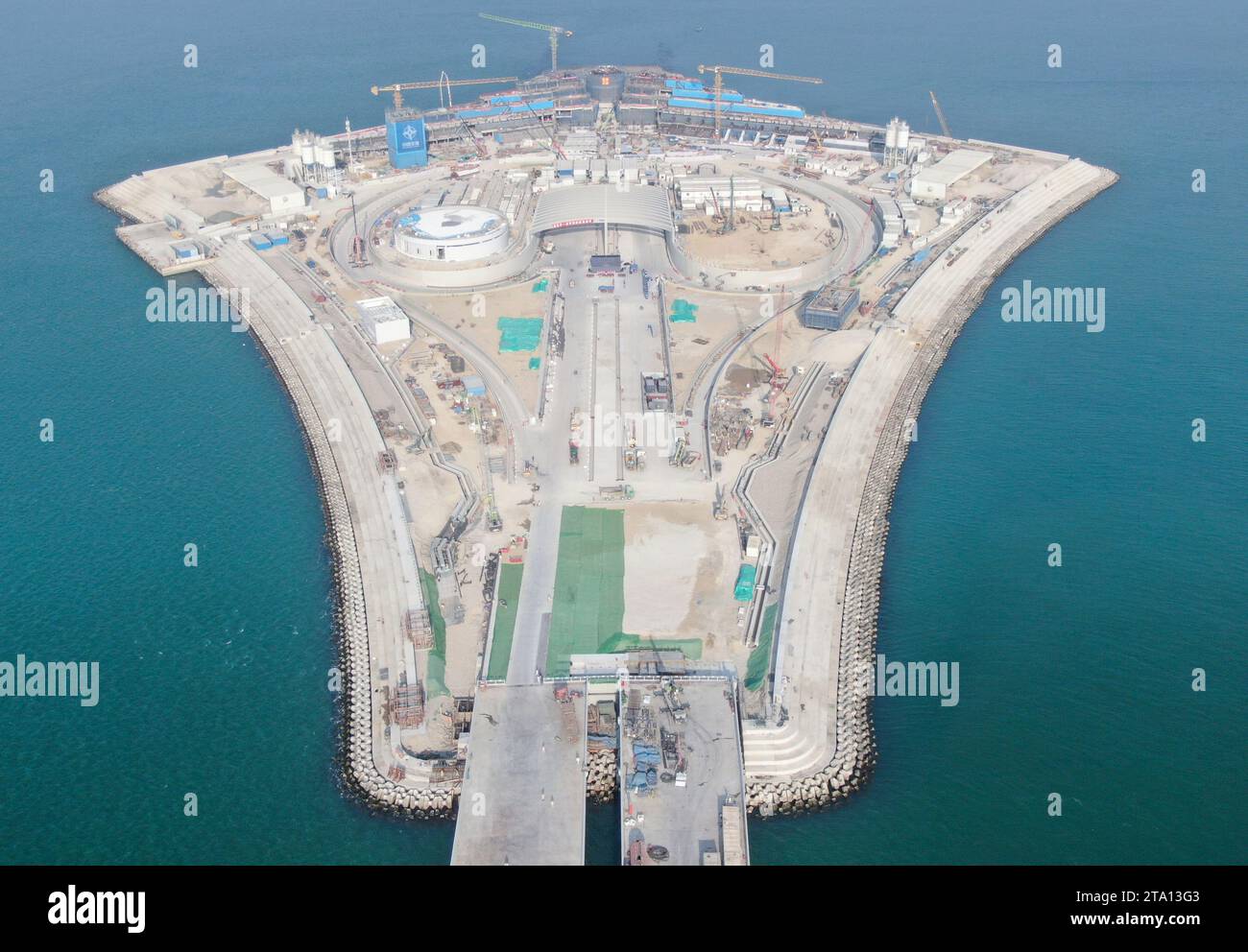 (231128) -- ZHONGSHAN, Nov. 28, 2023 (Xinhua) -- This aerial photo taken on Nov. 27, 2023 shows the west artificial island of the Shenzhen-Zhongshan link in south China's Guangdong Province. A cross-sea highway project between the cities of Shenzhen and Zhongshan in south China's Guangdong Province is one step closer to completion.   The last pouring of concrete was put in place on Tuesday, as work on the immersed tube underwater tunnel, which spans around 6.8 km, is nearing its end, said Guangdong Provincial Communication Group Co., Ltd.    The tunnel is part of a 24-km-long highway connectin Stock Photo