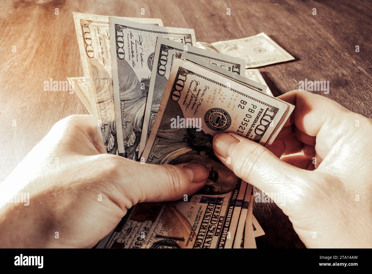 Dollars in hands - money counting. Finance and economics concept. Selective focus. Vintage coloring. Stock Photo