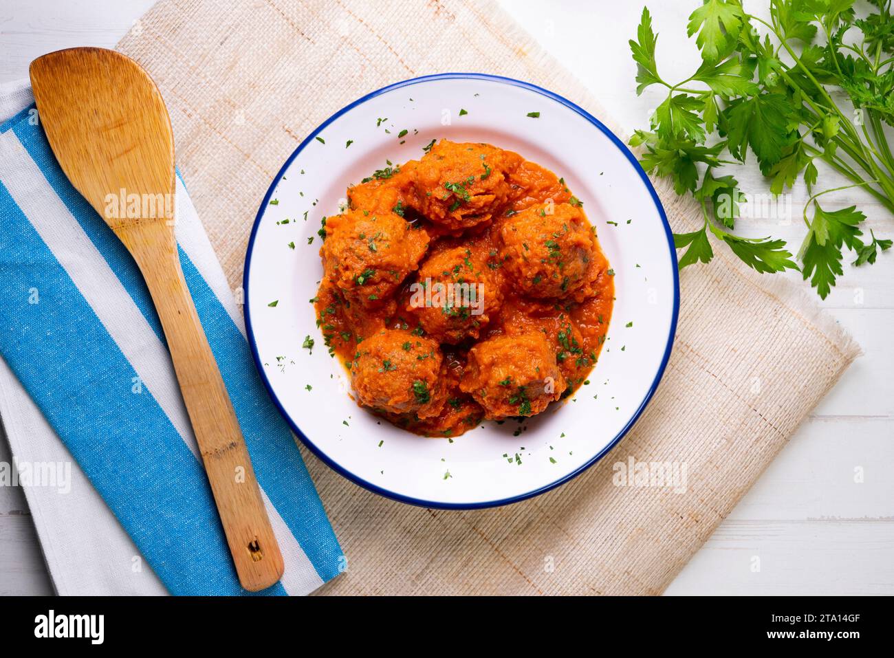 Meat meatballs with tomato sauce and vegetables. Traditional Spanish
