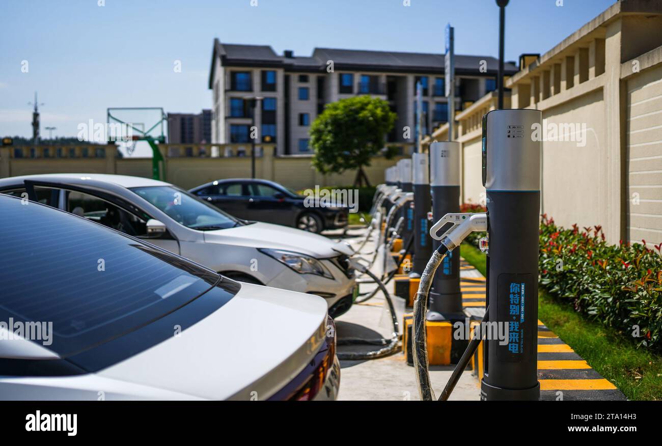 Guiyang. 17th Oct, 2023. This photo taken on Oct. 17, 2023 shows new energy vehicles being charged at a charging station in Gujiao Township of Bouyei-Miao Autonomous Prefecture of Qiannan, southwest China's Guizhou Province. Credit: Tao Liang/Xinhua/Alamy Live News Stock Photo