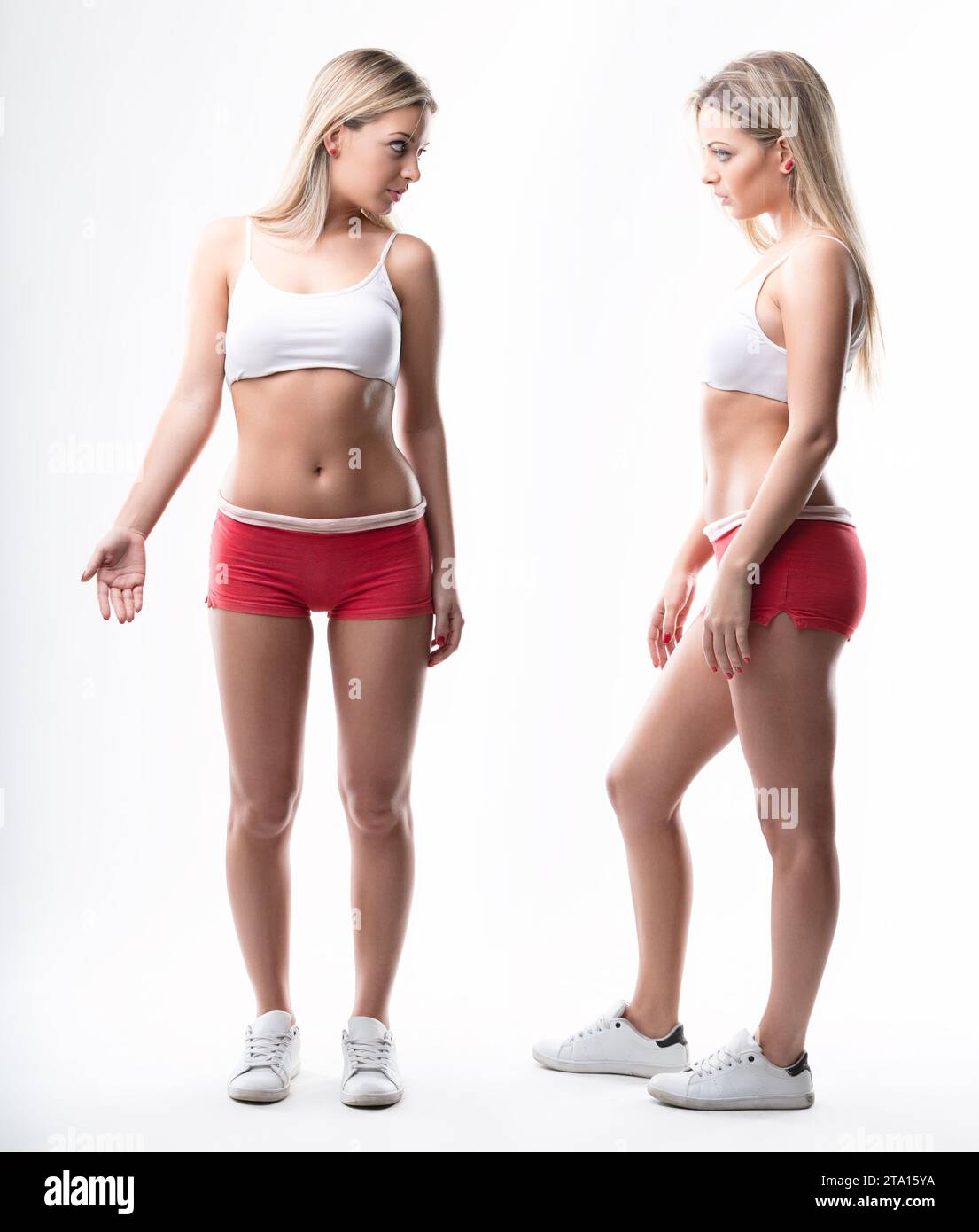 fit blonde woman critically examines her body, her own harshest judge Stock Photo