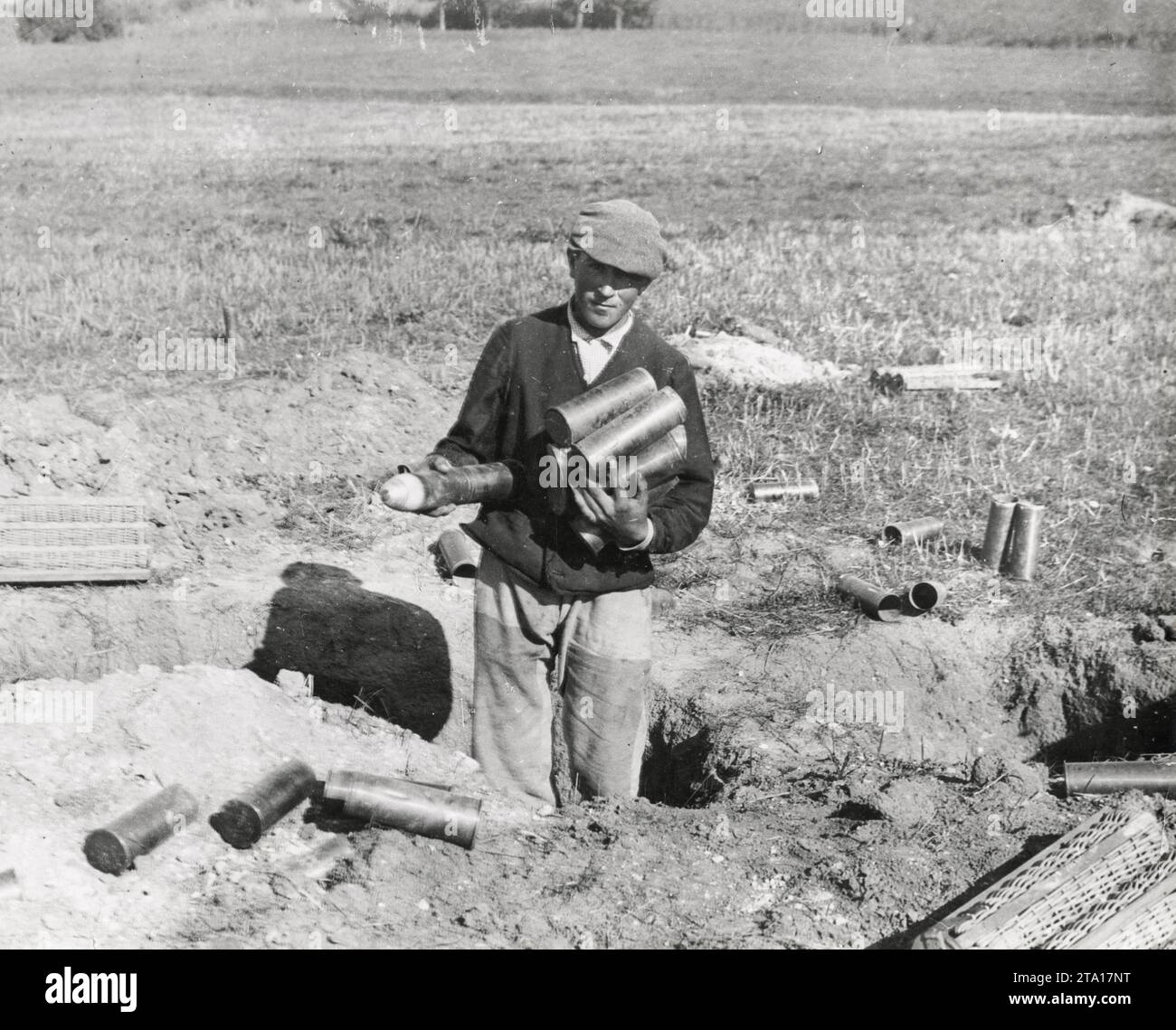 WW1 World War I - A French villager collecting shells left behind in trenches by German troops Stock Photo
