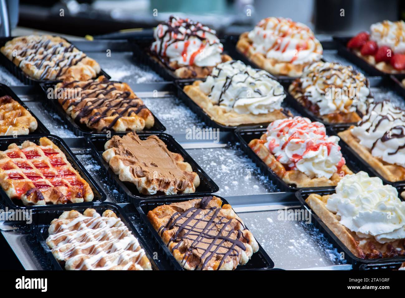 Waffles and Waffle, typical pastries with variety of flavors, in Brussels Belgium, sold in many shops in capitol of Europe Stock Photo