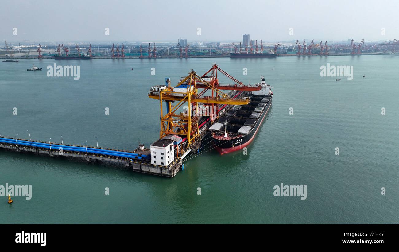 (231128) -- QINZHOU, Nov. 28, 2023 (Xinhua) -- This aerial photo taken on Nov, 24, 2023 shows the coal wharf of Qinzhou Port in Qinzhou City, south China's Guangxi Zhuang Autonomous Region. Started as a small fishing village in 1992, the Qinzhou Port of south China's Guangxi has been constructed into a modern international pivotal hub along the New International Land-Sea Trade Corridor after 30 years of development. An automated container terminal for sea-rail intermodal services has been constructed in Qinzhou Port, along with the industrial cluster thriving at the Qinzhou Port section of Ch Stock Photo