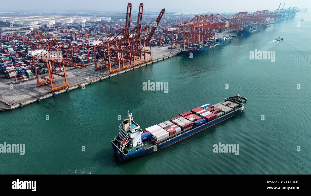 (231128) -- QINZHOU, Nov. 28, 2023 (Xinhua) -- This aerial photo taken on Nov. 24, 2023 shows a container vessel setting off from the Qinzhou Port in Qinzhou City, south China's Guangxi Zhuang Autonomous Region. Started as a small fishing village in 1992, the Qinzhou Port of south China's Guangxi has been constructed into a modern international pivotal hub along the New International Land-Sea Trade Corridor after 30 years of development. An automated container terminal for sea-rail intermodal services has been constructed in Qinzhou Port, along with the industrial cluster thriving at the Qinz Stock Photo