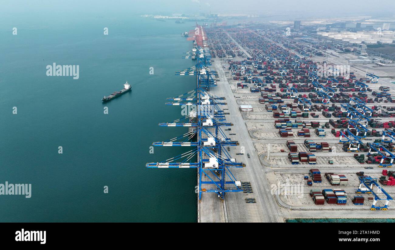 (231128) -- QINZHOU, Nov. 28, 2023 (Xinhua) -- This aerial photo taken on Nov. 24, 2023 shows the Qinzhou Port in Qinzhou City, south China's Guangxi Zhuang Autonomous Region. Started as a small fishing village in 1992, the Qinzhou Port of south China's Guangxi has been constructed into a modern international pivotal hub along the New International Land-Sea Trade Corridor after 30 years of development. An automated container terminal for sea-rail intermodal services has been constructed in Qinzhou Port, along with the industrial cluster thriving at the Qinzhou Port section of China (Guangxi) Stock Photo