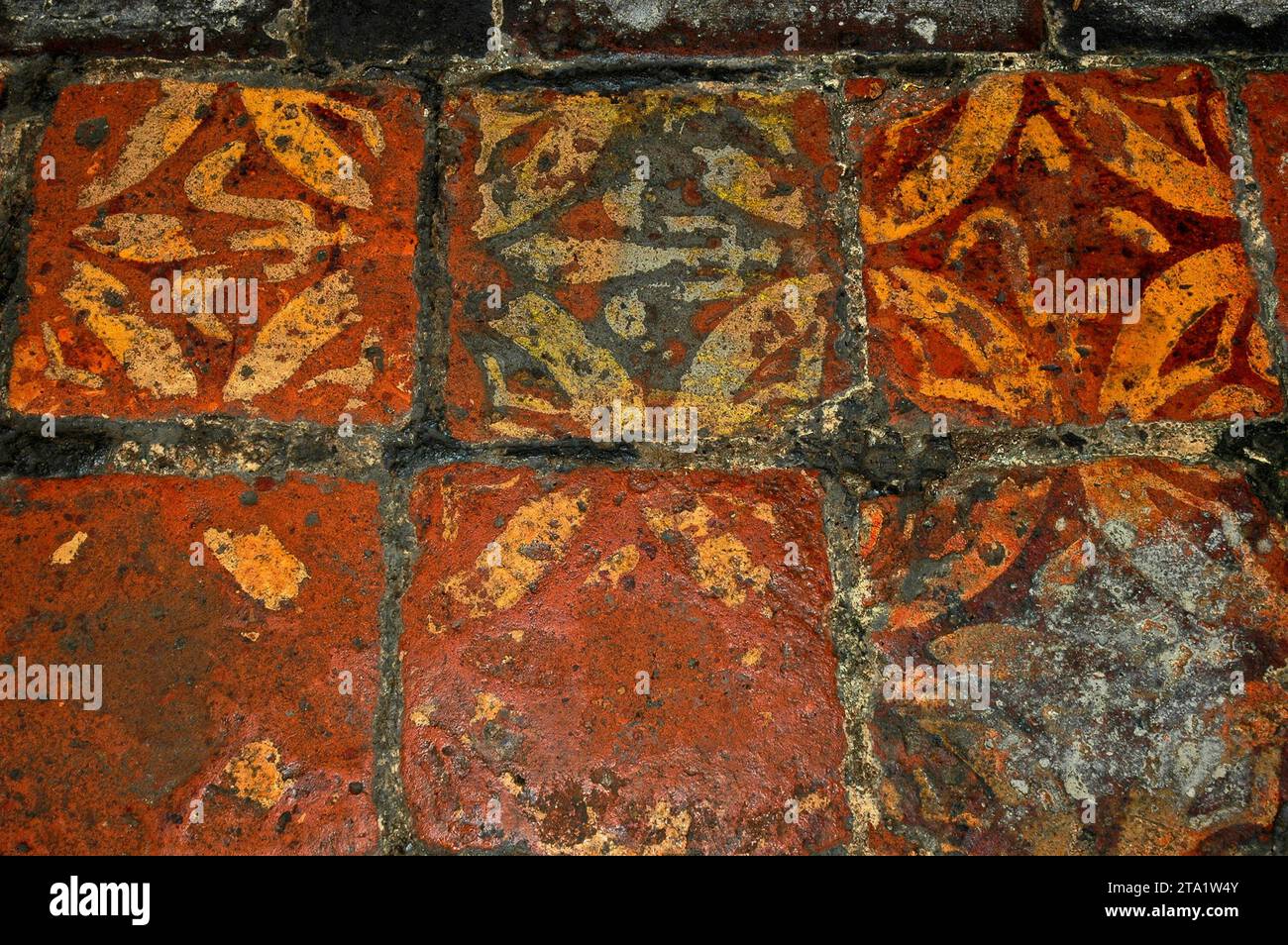 Timeworn encaustic tiles on floor of medieval Parish Church of Holy ...