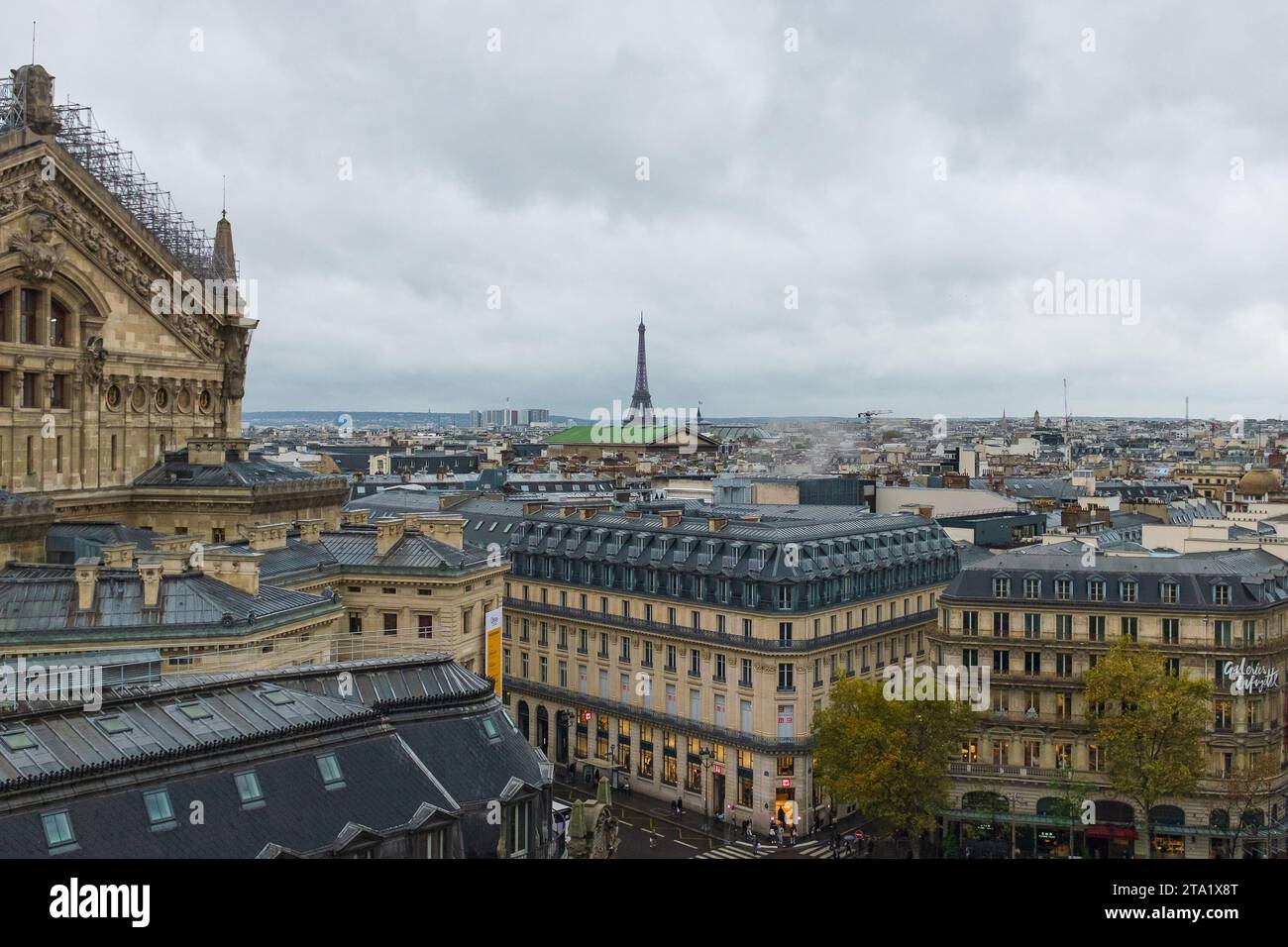 France, 2023. Panorama of the Haussmann architecture of Paris, with the Opera Garnier under renovation and the Eiffel Tower in the background Stock Photo
