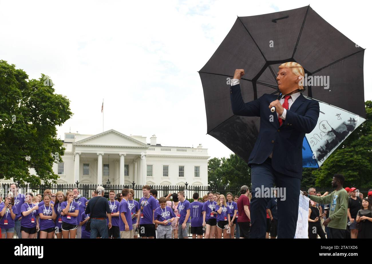 Washington, DC - June 02, 2018: Street performer wears a Trump mask and  mocked from current American president near White House. Stock Photo