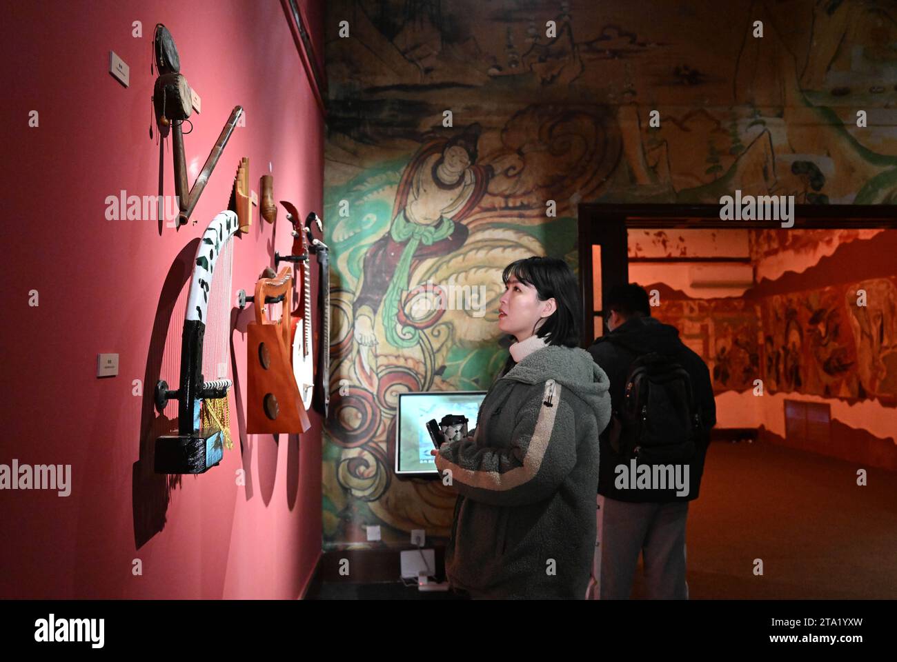 (231128) -- TIANJIN, Nov. 28, 2023 (Xinhua) -- Visitors view exhibits at an exhibition themed on Dunhuang culture at the Tianjin Digital Art Museum in Tianjin, north China, Nov. 28, 2023. The exhibition will last until March 2024. (Xinhua/Sun Fanyue) Stock Photo