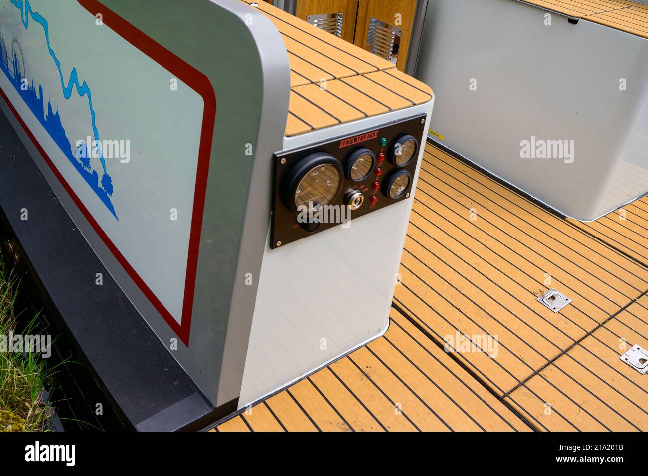 Engine control panel and pale colours deck boards on the stern of a new narrowboat on the UK waterways. Stock Photo