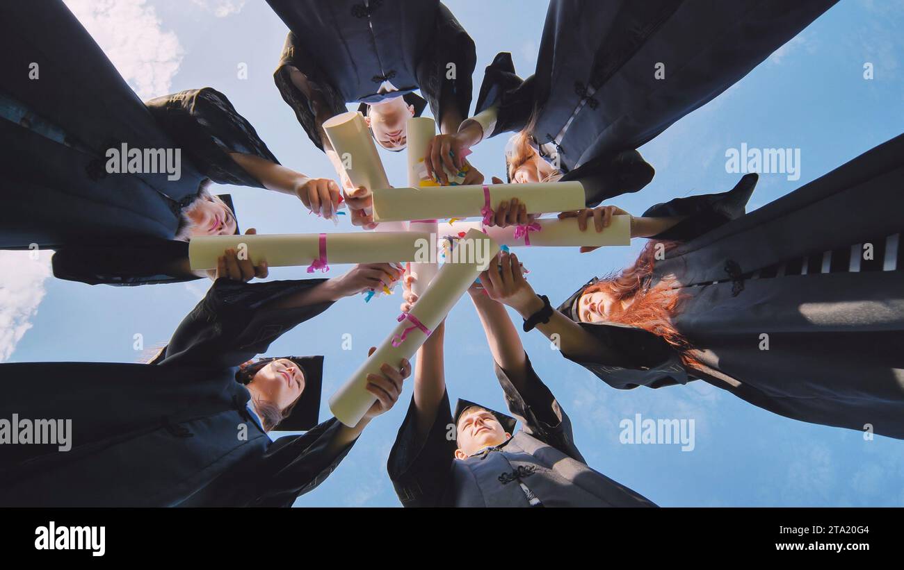 College students stand in a circle wearing black robes Stock Photo Alamy