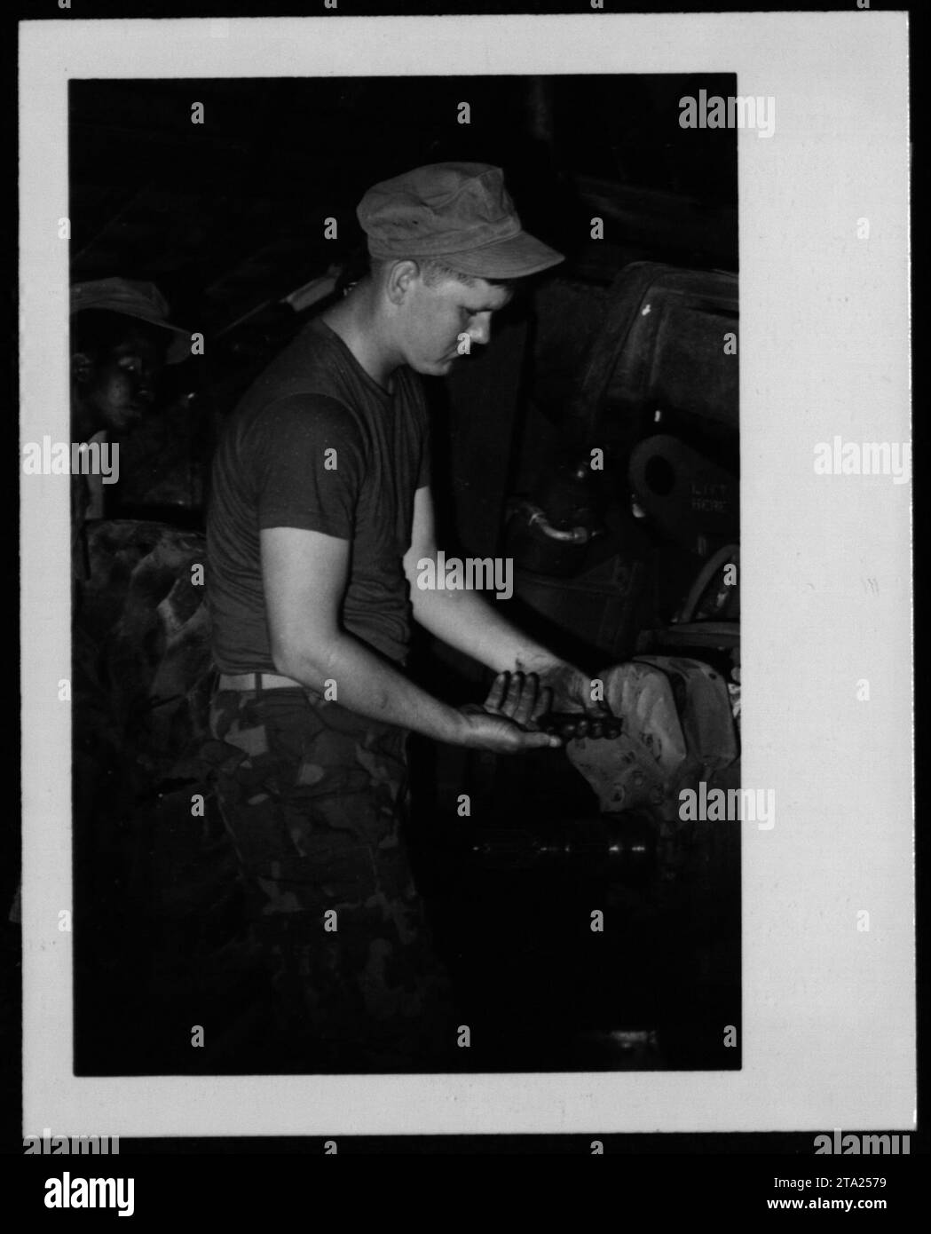Soldiers performing maintenance on military equipment during the
