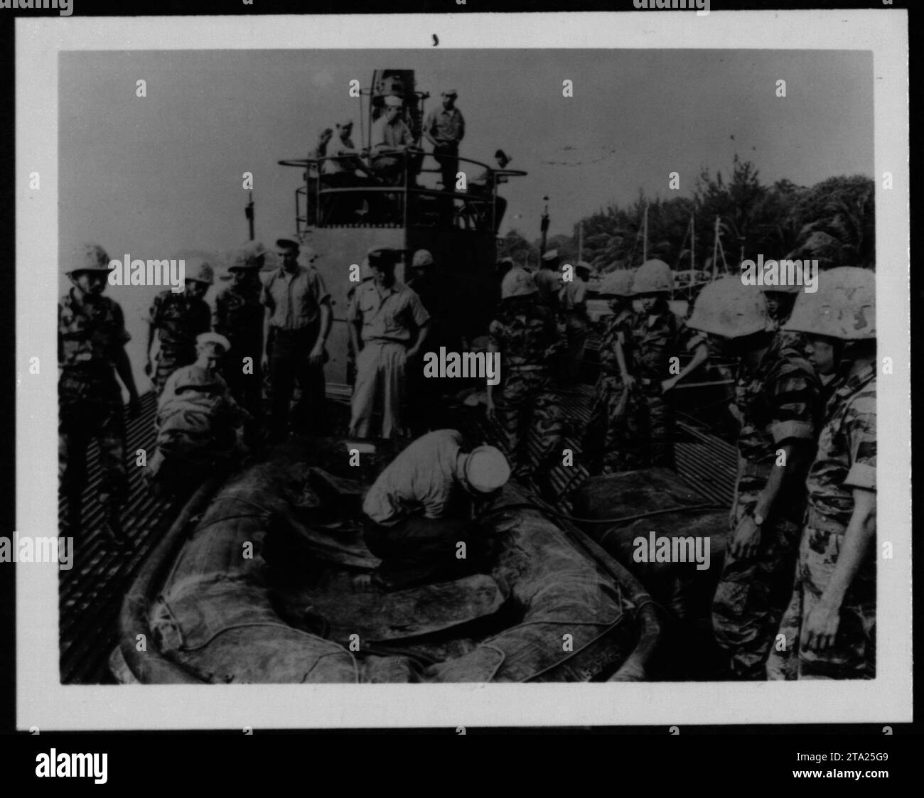 ARVN soldiers, including Vietnamese Marines, participate in military operations conducted in 1962 during the Vietnam War. This photo captures the presence and activities of the Army of the Republic of Vietnam alongside American forces. Stock Photo