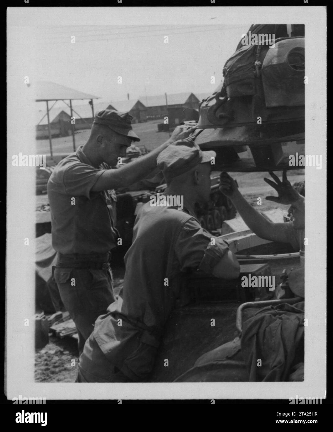 Soldiers perform maintenance on military equipment during the Vietnam