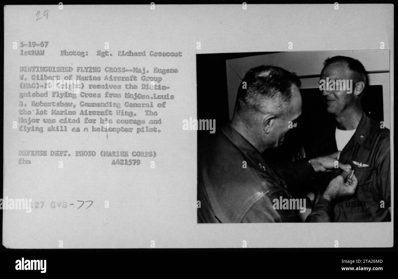 Major Eugena W. Gilbert of Marine Aircraft Group (MAG)-16 receives the Distinguished Flying Cross from Major General Louis S. Robertshaw, Commanding General of Marine Aircraft Wing, on May 29, 1967. Major Gilbert, a helicopter pilot, was honored for his courage and flying skill. This photograph was taken by Sgt. Richard Groscost, LetMAN Photographer, and is part of the USKO collection. Stock Photo