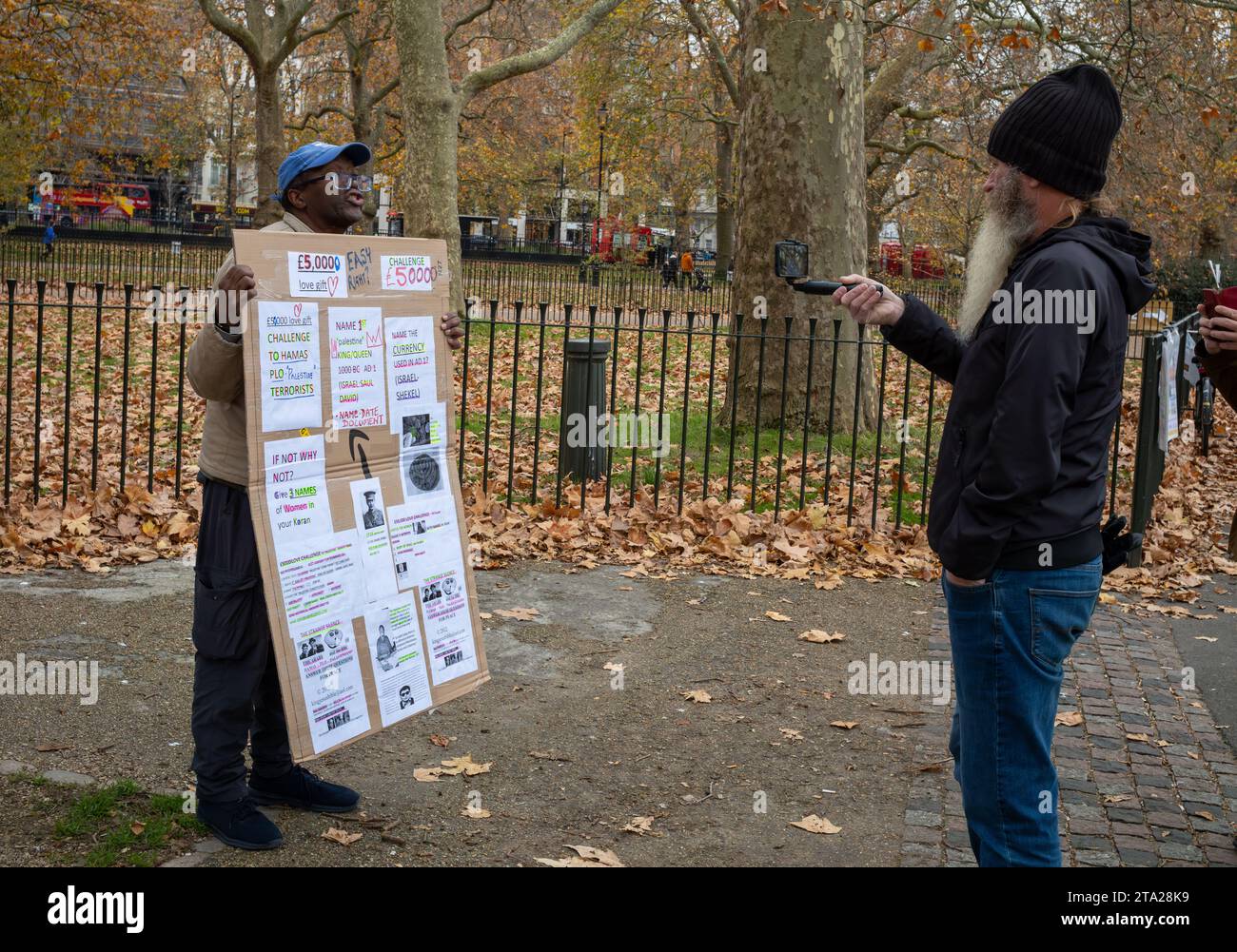 An evangelical Christian at Speaker's Corner in Hyde Park, London, is filmed as he talks by a man with a beard. Stock Photo