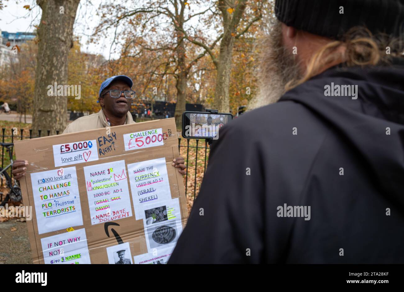 An evangelical Christian at Speaker's Corner in Hyde Park, London, is filmed as he talks by a man with a beard. Stock Photo