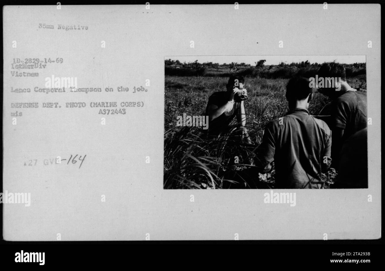 A combat photographer, Larry Burrows from Time/Life, captured Lance Corporal Thompson at work during the Vietnam War. The photograph, with the assigned negative code 10-2829-14-69 IstkerDiv Vietnem, shows the daily activities of a Marine Corps member, with the Defense Department providing the official photo under the code A372443 *27 GVB-764. Stock Photo