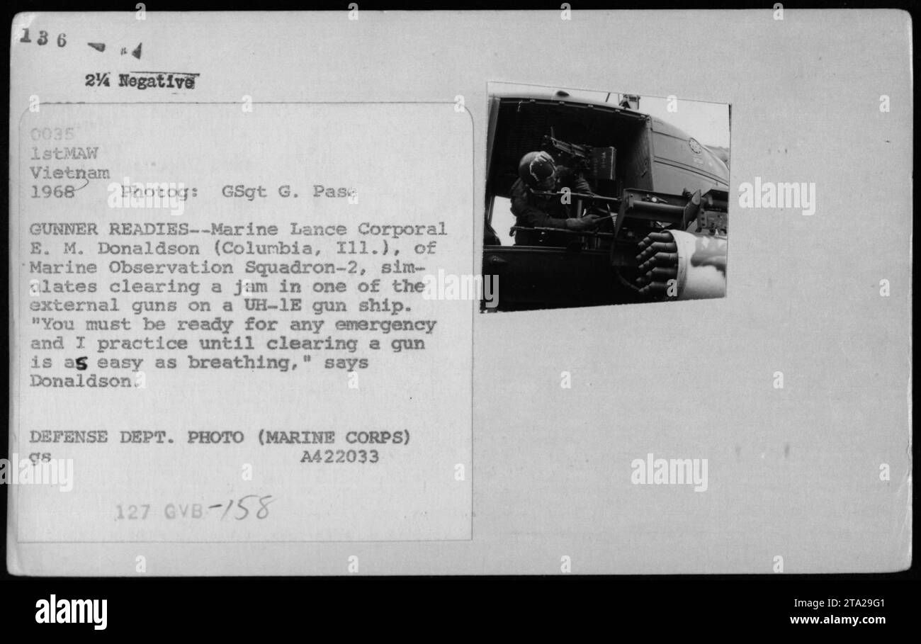 A Marine gunner from Observation Squadron-2 simulates clearing a jam in an external gun on a UH-1E gun ship in Vietnam, 1968. Lance Corporal E. M. Donaldson emphasizes the importance of being prepared for any emergency and regularly practicing gun maintenance. Defense Department photograph by GSgt G. Pase. Stock Photo