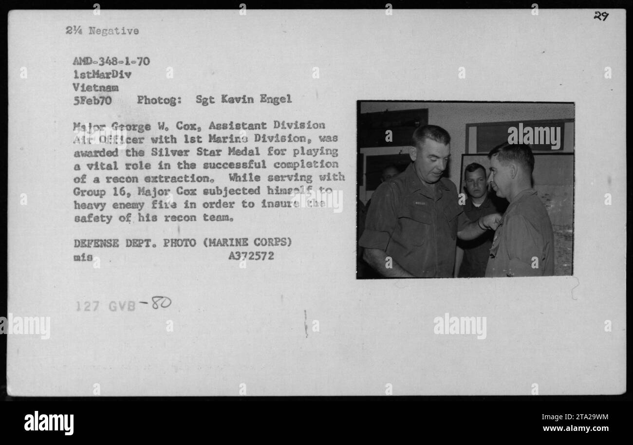 On February 5, 1970, Major George W. Cox, Assistant Division Air Officer with 1st Marine Division, received the Silver Star Medal. He played a crucial role in a recon extraction operation, subjecting himself to intense enemy fire to ensure the safety of his team. This photograph captures the moment of the award ceremony. Stock Photo
