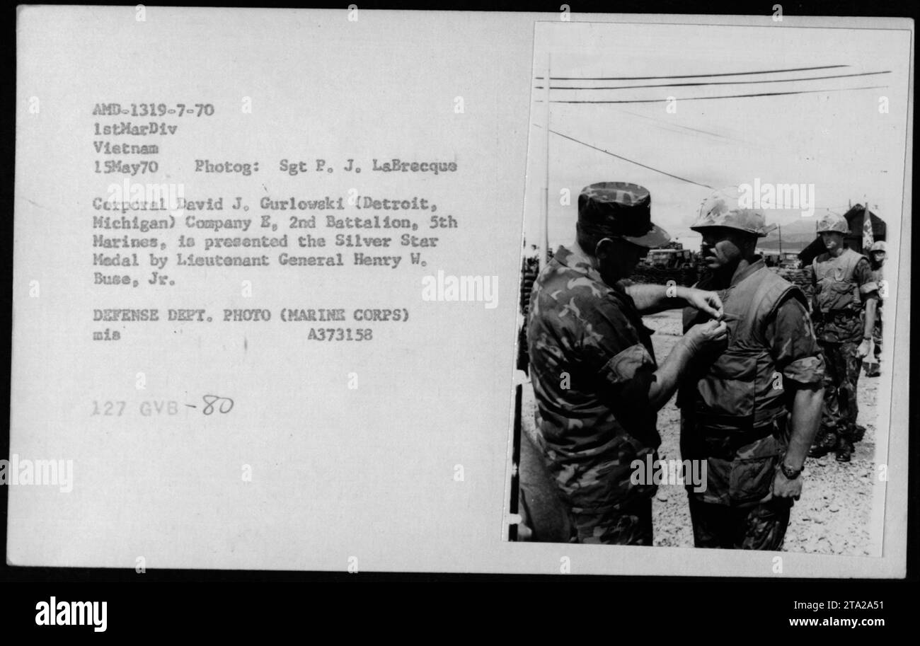 Corporal David J. Gurlowski from Detroit, Michigan, of Company E, 2nd Battalion, 5th Marines, is presented with the Silver Star Medal by Lieutenant General Henry W. Buse, Jr., on May 15, 1970, in Vietnam. This photograph captures the ceremony attended by members of the 1st Marine Division. Stock Photo