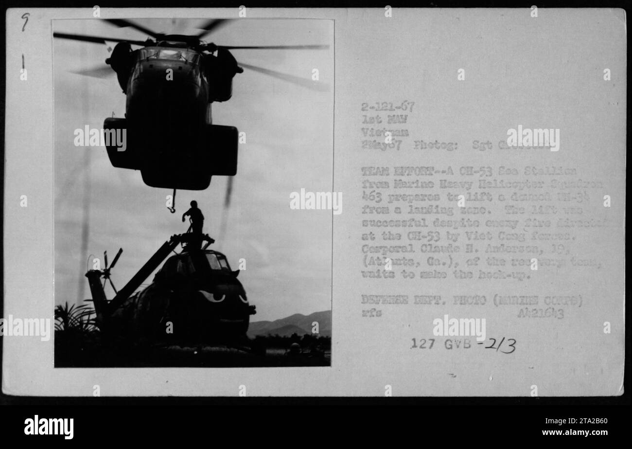 On May 2, 1967, a CH-53 Eca Stallion from Marine Heavy Helicopter Squadron 463 prepared to lift a damaged UH-34 helicopter from a landing zone in Vietnam, with Corporal Claude H. Anderson assisting in the recovery. Stock Photo