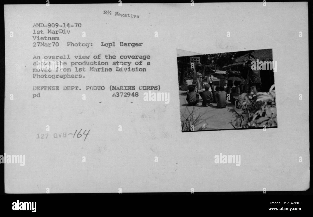 Combat photographers from the 1st Marine Division document the making of a movie during the Vietnam War. This image gives an overall view of the behind-the-scenes coverage by Larry Burrows and Lepl Barger on March 27, 1970, in Vietnam. (Note: Description includes image details and official identification numbers.) Stock Photo