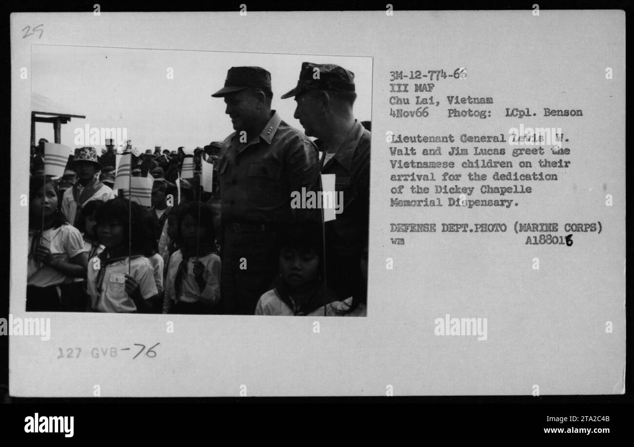 Lieutenant General Levis W. Walt and Jim Lucas greet Vietnamese children on their arrival for the dedication of the Dickey Chapelle Memorial Dispensary in Chu Lai, Vietnam, on November 4, 1966. The photograph was taken by LCpl. Benson. Stock Photo