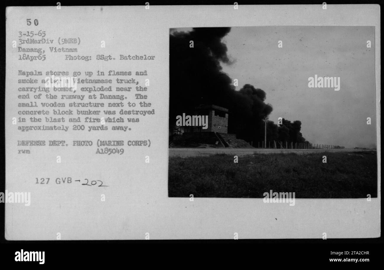 Napalm stores explode and set a small structure on fire after a Vietnamese truck carrying bombs exploded near Danang's runway. The blast, which occurred around 200 yards away, was captured in this photograph taken on April 18, 1965. The image is classified as Defense Department photo (Marine Corps) A185049 Xwm 127 GVB-202. Stock Photo