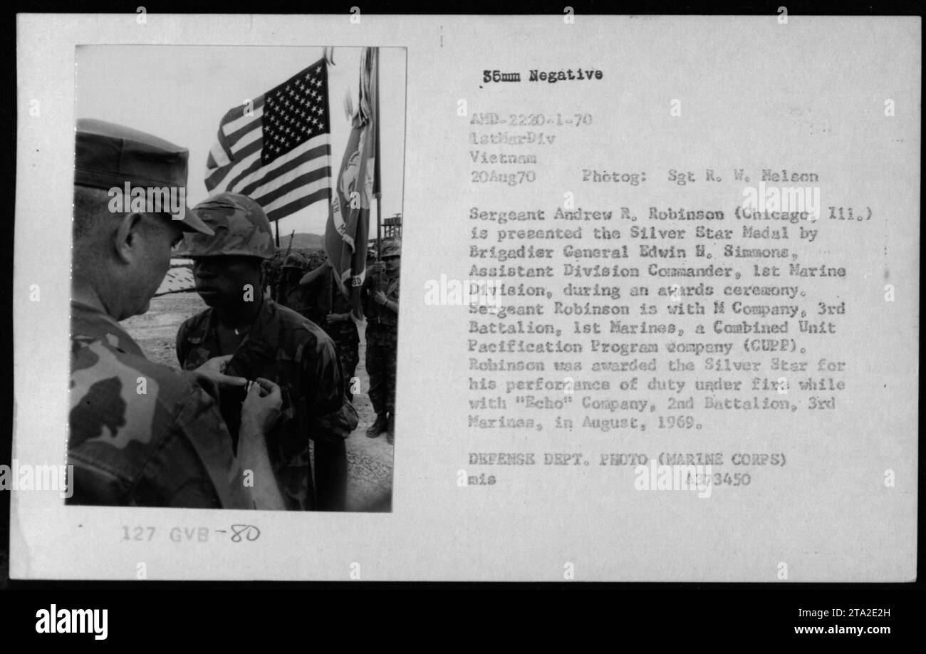 Sgt. Andrew R. Robinson of M Company, 3rd Battalion, 1st Marines, receives the Silver Star Medal from Brigadier General Edvin H. Simmons during an awards ceremony in Vietnam on August 20, 1970. Sgt. Robinson was recognized for his heroic actions while serving with 'Echo' Company, 2nd Battalion, 3rd Marines in August 1969. This photo is from the Defense Department's collection. Stock Photo