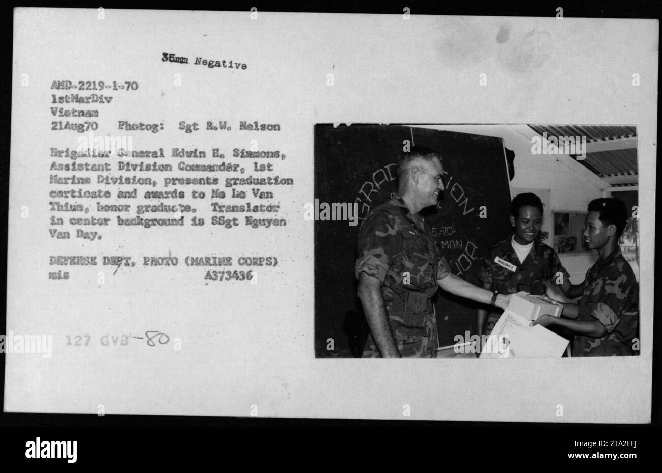 'Brigadier General Edvin H. Simmons, Assistant Division Commander of the 1stMarDiv Vietnam, presents graduation certificate and awards to No Lie Van Thius, honor graduate, during a ceremony on August 21, 1970. Translator SSgt Nguyen Van Day can be seen in the background. Image sourced from the Defense Department, US Marine Corps.' Stock Photo