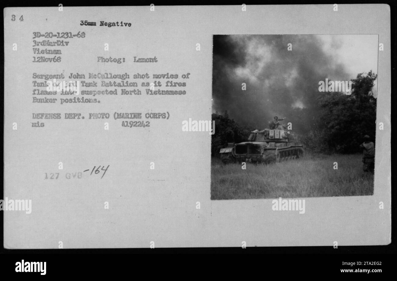 Marine Sergeant John McCullough captures footage of a tank from the 3rd Tank Battalion firing flames into suspected enemy positions during a military operation in Vietnam on November 12, 1968. This photograph was taken by combat photographer Larry Burrows for Time/Life magazine. (Photo: U.S. Department of Defense, Marine Corps) Stock Photo